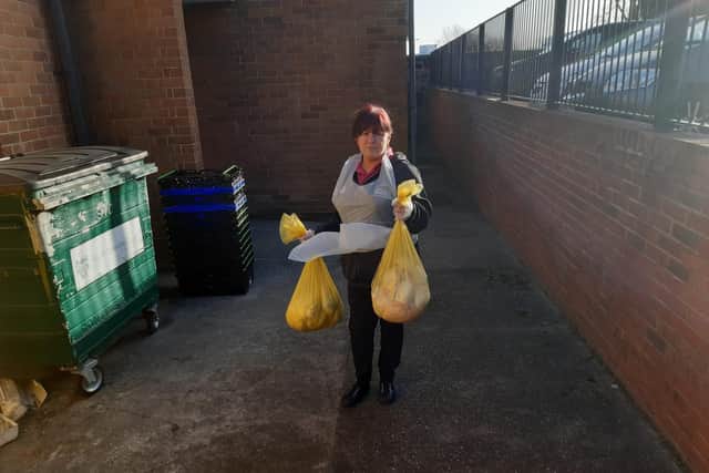 Nursery practitioner Marie Gibson disposing of some of the bags.