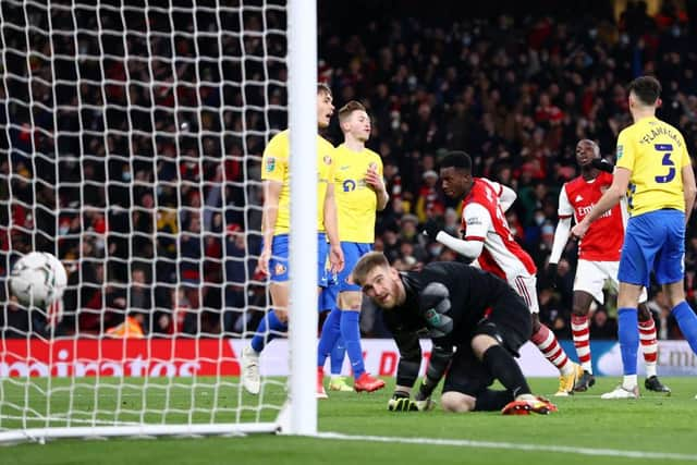 Eddie Nketiah of Arsenal scores their team's fourth goal and his hat-trick past Lee Burge of Sunderland. (Photo by Ryan Pierse/Getty Images)