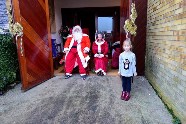 Myla Herbertson with Santa and Mrs Claus.