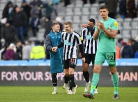 Kieran Trippier, Matt Targett and Jamaal Lascelles of Newcastle United share a joke after the friendly match between Newcastle United and Rayo Vallecano at St James' Park on December 17, 2022 in Newcastle upon Tyne, England. (Photo by Stu Forster/Getty Images)
