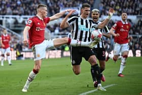 Manchester United's Scottish midfielder Scott McTominay (L) vies with Newcastle United's Dutch defender Sven Botman (C) during the English Premier League football match between Newcastle United and Manchester United at St James' Park in Newcastle-upon-Tyne, north east England on April 2, 2023. (Photo by Oli SCARFF / AFP)