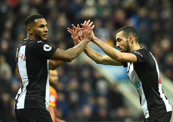 NEWCASTLE UPON TYNE, ENGLAND - FEBRUARY 01: Jamaal Lascelles and Nabil Bentaleb of Newcastle United embrace during the Premier League match between Newcastle United and Norwich City at St. James Park on February 01, 2020 in Newcastle upon Tyne, United Kingdom. (Photo by Mark Runnacles/Getty Images)