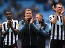 Newcastle United head coach Eddie Howe with Alexander Isak and Dan Burn after the final whistle at the Etihad Stadium.