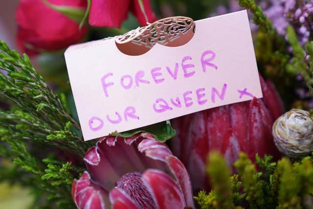 A message left on flowers laid outside Buckingham Palace, London, following the death of Queen Elizabeth II. Picture: PA.