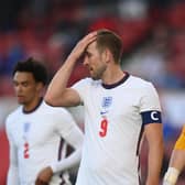 Harry Kane and Jordan Pickford playing for England.