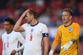 Harry Kane and Jordan Pickford playing for England.