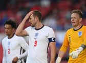 Harry Kane and Jordan Pickford playing for England.