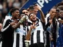 NEWCASTLE UPON TYNE, ENGLAND - MAY 07:  Newcastle United players Vurnon Anita (r) and Achraf Lazaar (c) celebrate by taking selfie photographs after winning the Sky Bet Championship match between Newcastle United and Barnsley at St James' Park on May 7, 2017 in Newcastle upon Tyne, England.  (Photo by Stu Forster/Getty Images)