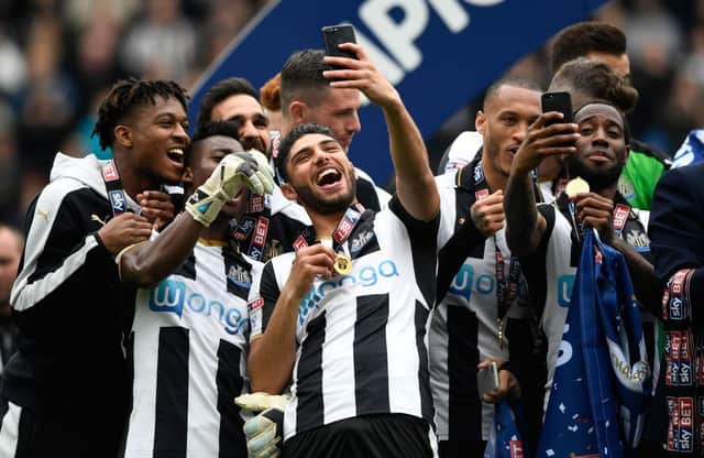 NEWCASTLE UPON TYNE, ENGLAND - MAY 07: Newcastle United players Vurnon Anita (r) and Achraf Lazaar (c) celebrate by taking selfie photographs after winning the Sky Bet Championship match between Newcastle United and Barnsley at St James' Park on May 7, 2017 in Newcastle upon Tyne, England. (Photo by Stu Forster/Getty Images)