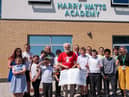 Les Milne from Save the Children with pupils from Harry Watts Academy