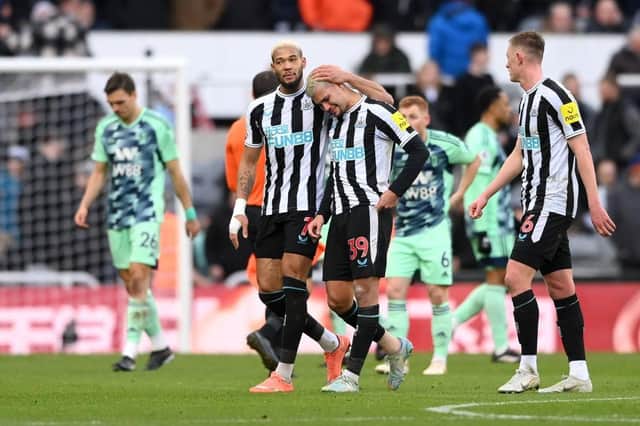 Bruno Guimaraes leaves the pitch in tears, consoled by Joelinton of Newcastle United at half time during the Premier League match between Newcastle United and Fulham FC at St. James Park on January 15, 2023 in Newcastle upon Tyne, England. (Photo by Stu Forster/Getty Images)