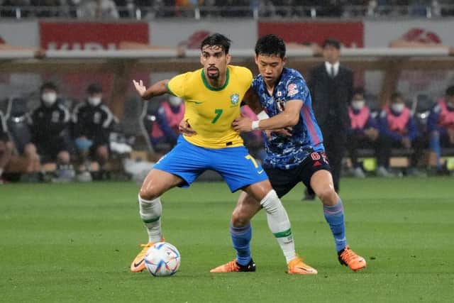 Lucas Paqueta of Brazil controls the ball under pressure of Wataru Endo of Japan during the international friendly match between Japan and Brazil at National Stadium on June 6, 2022 in Tokyo, Japan. (Photo by Koji Watanabe/Getty Images)