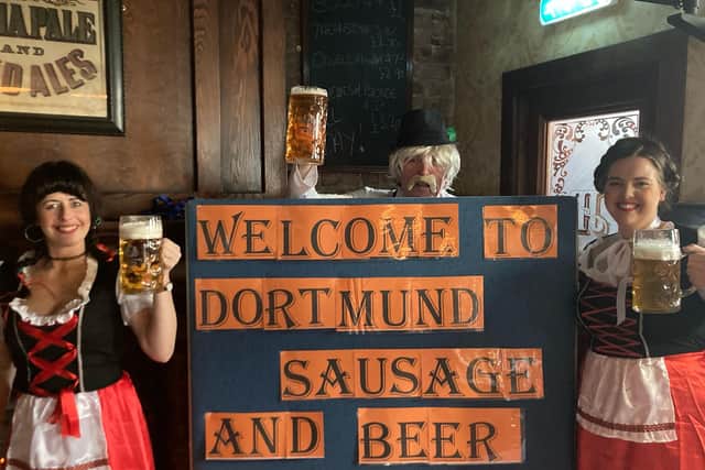 Prost! Dressed for the occasion at the Albion from left, Fräulein Susan McElwee, Herr Jess McConnell and Fräulein Amy Giles.