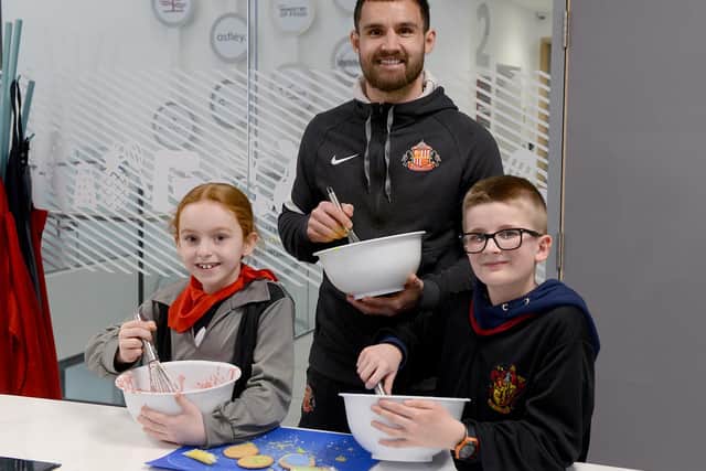 SAFC star Bailey Wright making Harry Potter themed biscuits with Dame Dorothy Primary School children Oliver Anderson and Ruby Horn.
Photograph: Alan Hewson