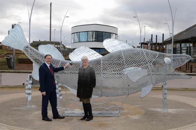 South Tyneside Council Deputy Leader Cllr Joan Atkinson and Andy Whittaker with the newly installed fish sculpture recycle bin at Sandhaven Beach.
