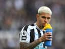 Newcastle player Bruno Guimaraes takes a drink from a lucozade bottle prior to the Premier League match between Newcastle United and Tottenham Hotspur at St. James Park on April 23, 2023 in Newcastle upon Tyne, England. (Photo by Stu Forster/Getty Images)