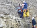 A boy was rescued from the cliff top by several emergency crews after getting stuck.