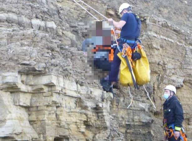 A boy was rescued from the cliff top by several emergency crews after getting stuck.