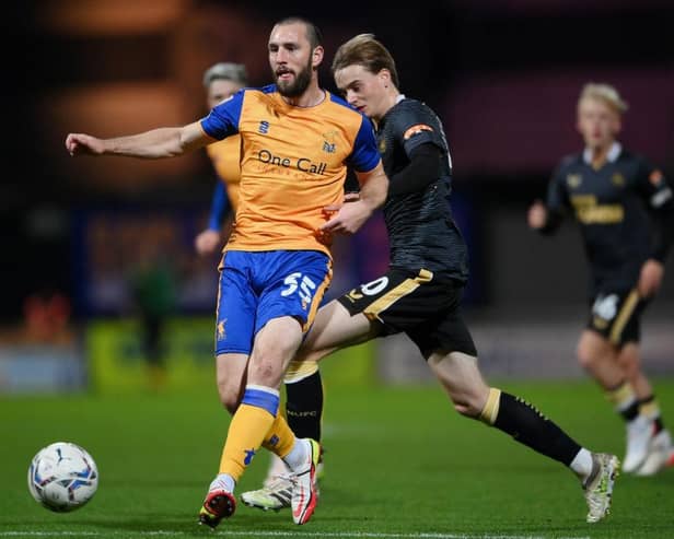 John-Joe O'Toole (L) of Mansfield Town is tackled by Lucas De Bolle of Newcastle United during the Papa John's EFL Trophy Group match between Mansfield  Town and Newcastle United U21 at  on November 09, 2021 in Mansfield, England. (Photo by Laurence Griffiths/Getty Images)