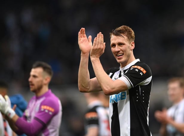Dan Burn applauds fans.