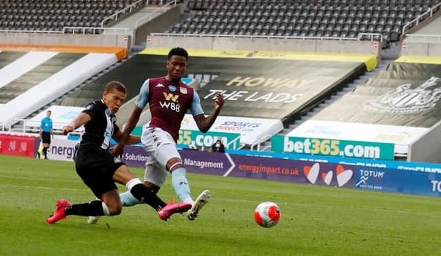 Newcastle United's English striker Dwight Gayle (L) shoots to score the opening goal during the English Premier League football match between Newcastle United and Aston Villa at St James' Park in Newcastle-upon-Tyne, north east England on June 24, 2020.