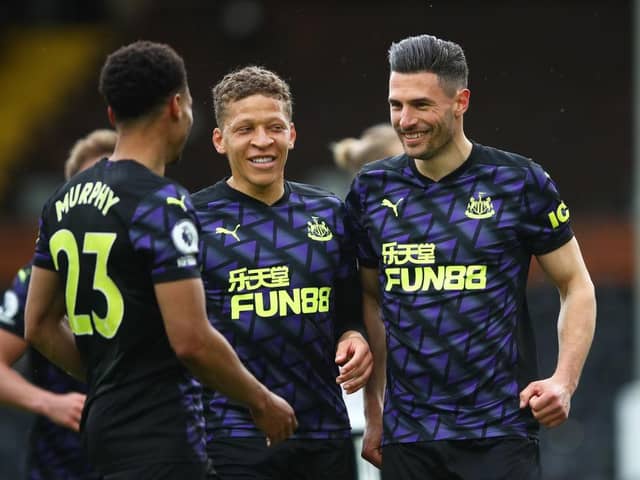 Fabian Schar of Newcastle United celebrates with Dwight Gayle and nu after scoring his sides second goal during the Premier League match between Fulham and Newcastle United at Craven Cottage on May 23, 2021 in London, England.
