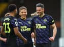 Fabian Schar of Newcastle United celebrates with Dwight Gayle and nu after scoring his sides second goal during the Premier League match between Fulham and Newcastle United at Craven Cottage on May 23, 2021 in London, England.