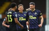 Fabian Schar of Newcastle United celebrates with Dwight Gayle and nu after scoring his sides second goal during the Premier League match between Fulham and Newcastle United at Craven Cottage on May 23, 2021 in London, England.