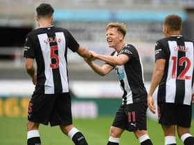 Newcastle United's Scottish midfielder Matt Ritchie (C) celebrates with Newcastle United's Swiss defender Fabian Schar (L) after scoring their first goal during the English Premier League football match between Newcastle United and Tottenham Hotspur at St James' Park in Newcastle-upon-Tyne, north-east England on July 15, 2020.