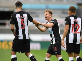 Newcastle United's Scottish midfielder Matt Ritchie (C) celebrates with Newcastle United's Swiss defender Fabian Schar (L) after scoring their first goal during the English Premier League football match between Newcastle United and Tottenham Hotspur at St James' Park in Newcastle-upon-Tyne, north-east England on July 15, 2020.
