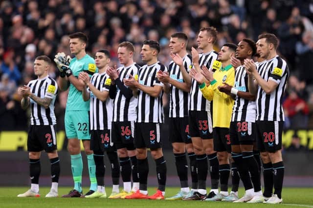 A general view of players of Newcastle United, as Bruno Guimaraes wears a signed Pele 10 shirt, as they hold a minutes applause in memory of former Brazil player Pele prior to the Premier League match between Newcastle United and Leeds United at St. James Park on December 31, 2022 in Newcastle upon Tyne, England. (Photo by George Wood/Getty Images)