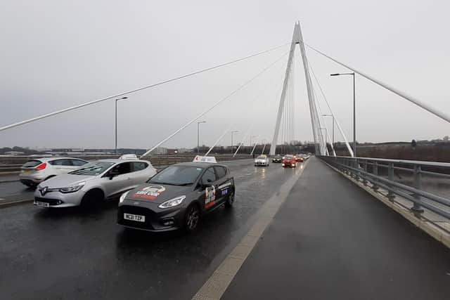 Driving instructors cross the Northern Spire Bridge as part of a protest convoy against the planned closure of South Tyneside's driving test centre 28/02/22