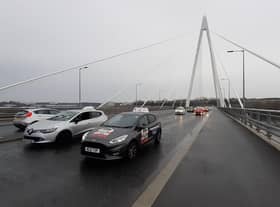 Driving instructors cross the Northern Spire Bridge as part of a protest convoy against the planned closure of South Tyneside's driving test centre 28/02/22