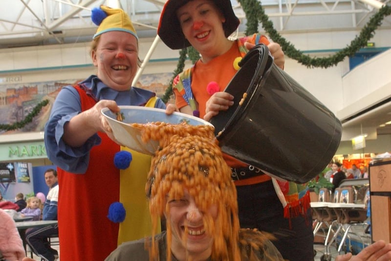 This brave fundraiser was taking a bath in beans in the shopping centre in 2004. But who can tell us more?