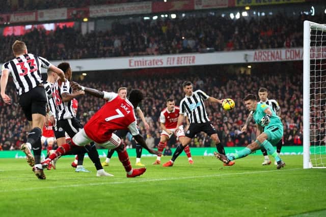 Nick Pope of Newcastle United makes a save from Bukayo Saka of Arsenal during the Premier League match between Arsenal FC and Newcastle United at Emirates Stadium on January 03, 2023 in London, England. (Photo by Julian Finney/Getty Images)