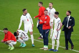 England manager Gareth Southgate (right) is dejected with is players following the penalty shoot out during the UEFA Euro 2020 Final at Wembley Stadium, London. Picture date: Sunday July 11, 2021.
