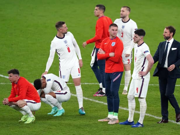England manager Gareth Southgate (right) is dejected with is players following the penalty shoot out during the UEFA Euro 2020 Final at Wembley Stadium, London. Picture date: Sunday July 11, 2021.