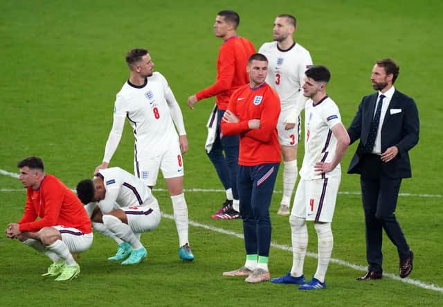 England manager Gareth Southgate (right) is dejected with is players following the penalty shoot out during the UEFA Euro 2020 Final at Wembley Stadium, London. Picture date: Sunday July 11, 2021.