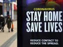People walk past a 'Stay Home Save Lives' sign on Broadmead in Bristol during England's third national lockdown to curb the spread of coronavirus. Under increased measures people can no longer leave their home without a reasonable excuse and schools must shut for most pupils. PA Photo. Picture date: Saturday January 9, 2021. See PA story HEALTH Coronavirus. Photo credit should read: Andrew Matthews/PA Wire