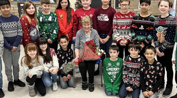 Retiring caretaker Joan Mulley, 80, surrounded by children from Hadrian Primary School.