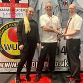 Chief coach Kevan Mitchinson and daughter Eleisha receive the team award on behalf of the Dokan Karate Club.