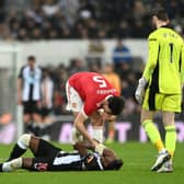 Manchester United's Harry Maguire checks on Newcastle United's Allan Saint-Maximin.