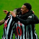 Newcastle's English midfielder Joe Willock (R) celebrates with teammates after scoring his team's first goal during the English Premier League football match between Newcastle United and Southampton at St James' Park in Newcastle-upon-Tyne, north east England on February 6, 2021.