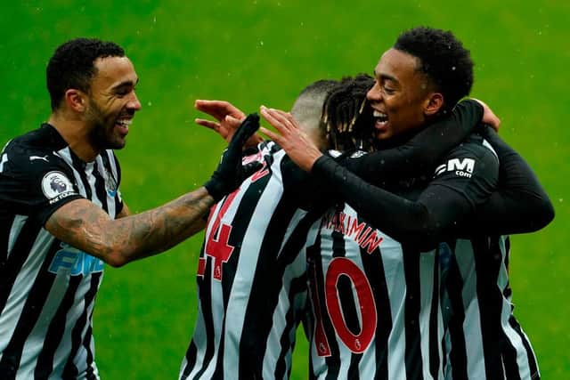 Newcastle's English midfielder Joe Willock (R) celebrates with teammates after scoring his team's first goal during the English Premier League football match between Newcastle United and Southampton at St James' Park in Newcastle-upon-Tyne, north east England on February 6, 2021.