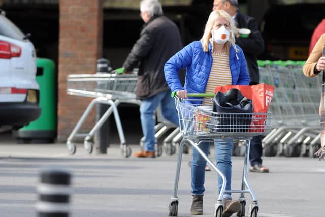 A shopper wears a protective mask at Boldon Colliery's Asda supermarket.