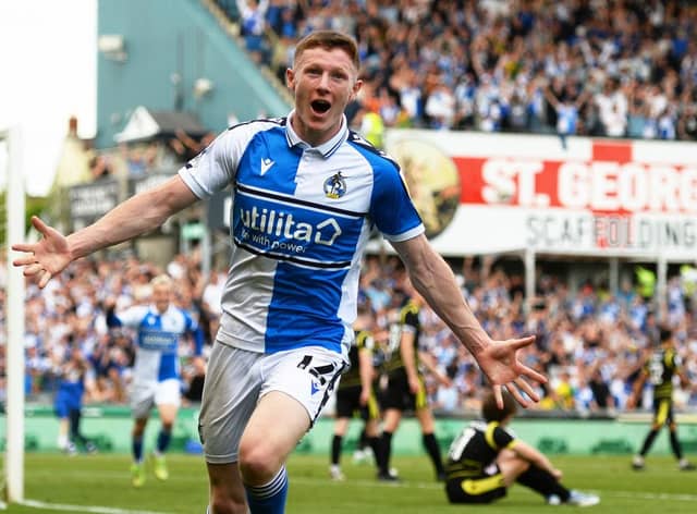 Elliot Anderson celebrates a scoring a promotion-winning goal for Bristol Rovers.