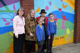 Maria Robinson (headteacher), Geri Mole (artist), Cllr Freda Geddes (l-r) with the mural
