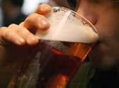 Picture of someone drinking a pint of beer. Pic: PA