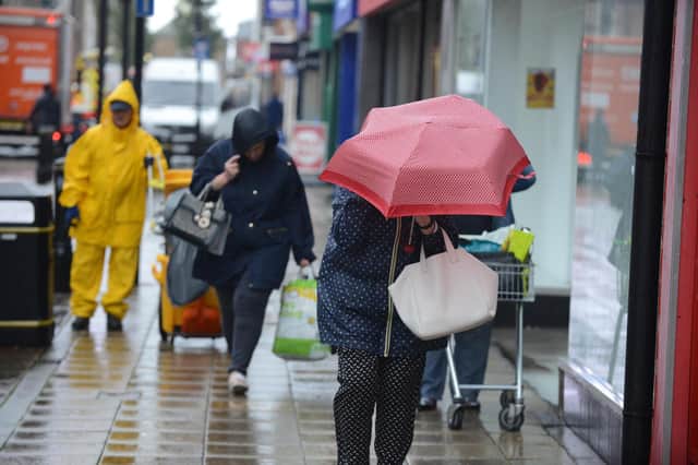Afternoon shoppers will have to deal with heavy rain and strong winds on King Street, South Shields. Picture by Stu Norton.