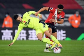 Southampton's English midfielder Che Adams (R) vies for the ball against Newcastle United's Swiss defender Fabian Schar (L) during the English Premier League football match between Southampton and Newcastle United at St Mary's Stadium in Southampton, southern England on November 6, 2020. (Photo by Stu Forster / POOL / AFP) / RESTRICTED TO EDITORIAL USE. No use with unauthorized audio, video, data, fixture lists, club/league logos or 'live' services. Online in-match use limited to 120 images. An additional 40 images may be used in extra time. No video emulation. Social media in-match use limited to 120 images. An additional 40 images may be used in extra time. No use in betting publications, games or single club/league/player publications. /  (Photo by STU FORSTER/POOL/AFP via Getty Images)